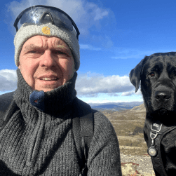 Face of a man called Rob and a black labrador called Baloo